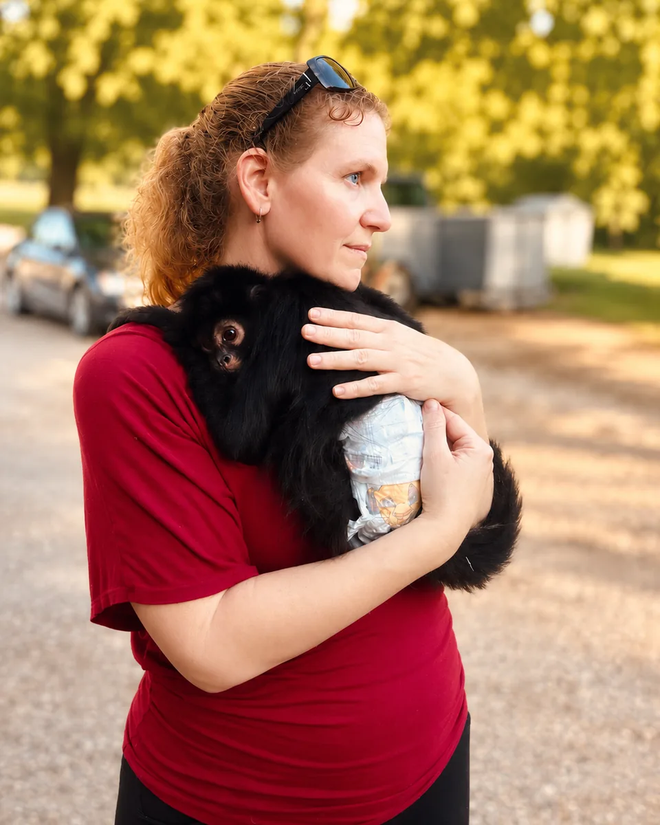 Bentley Oliver holding a spider monkey